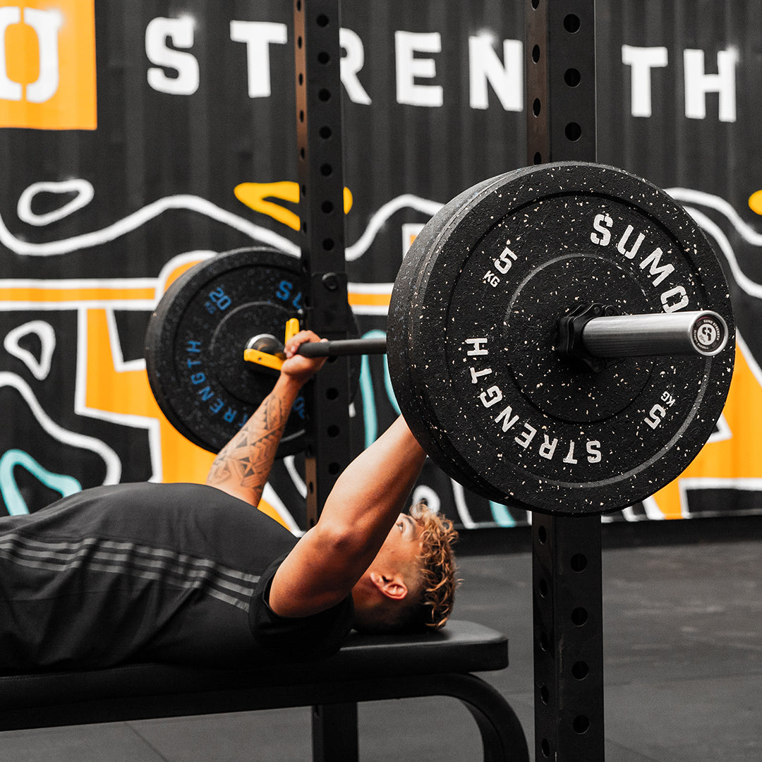 Bodybuilder performing bench Press (close view)